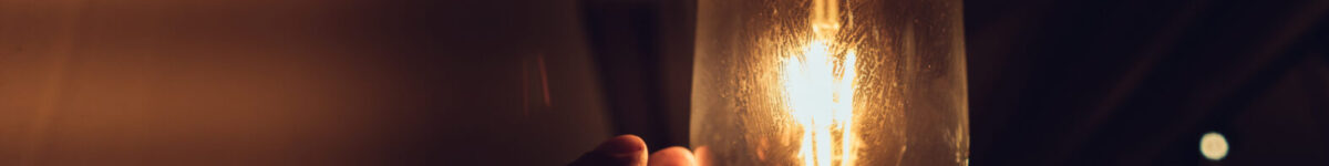 Почти 220 новосибирских домов остались без света 15 сентября Hand reaching for a vintage light bulb.